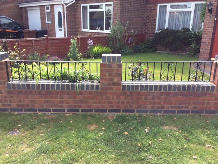 Garden wall with decorative steel railings